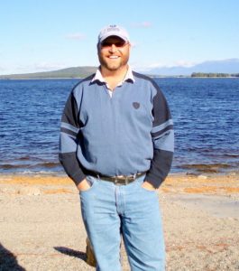 Ray Pasnen stands in from of Mt Katahdin at 5 Lakes Lodge.